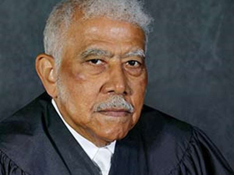 Color photo of Justice Revius O. Ortique Jr., wearing black judicial robes.