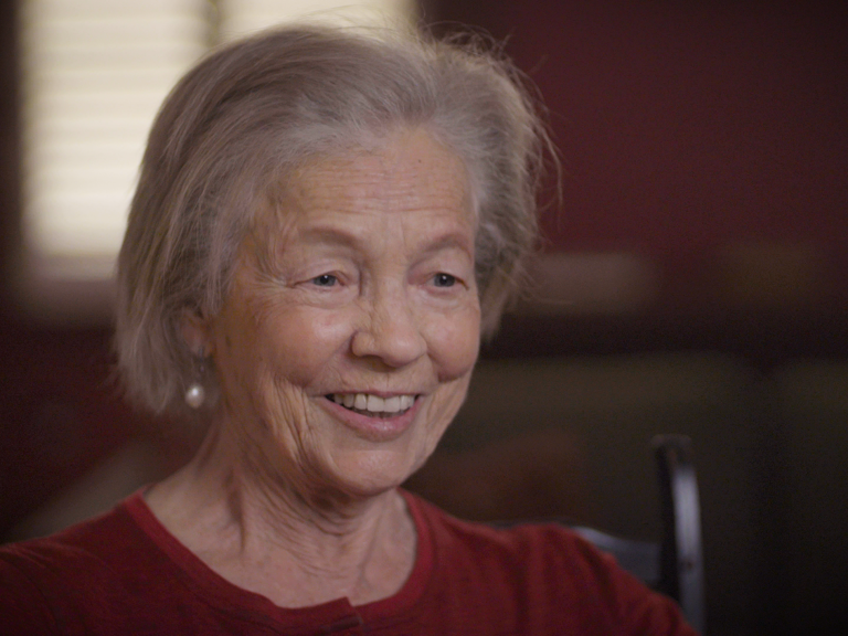 Color photo of Elizabeth Bartholet, smiling and seated indoors during her oral history interview.