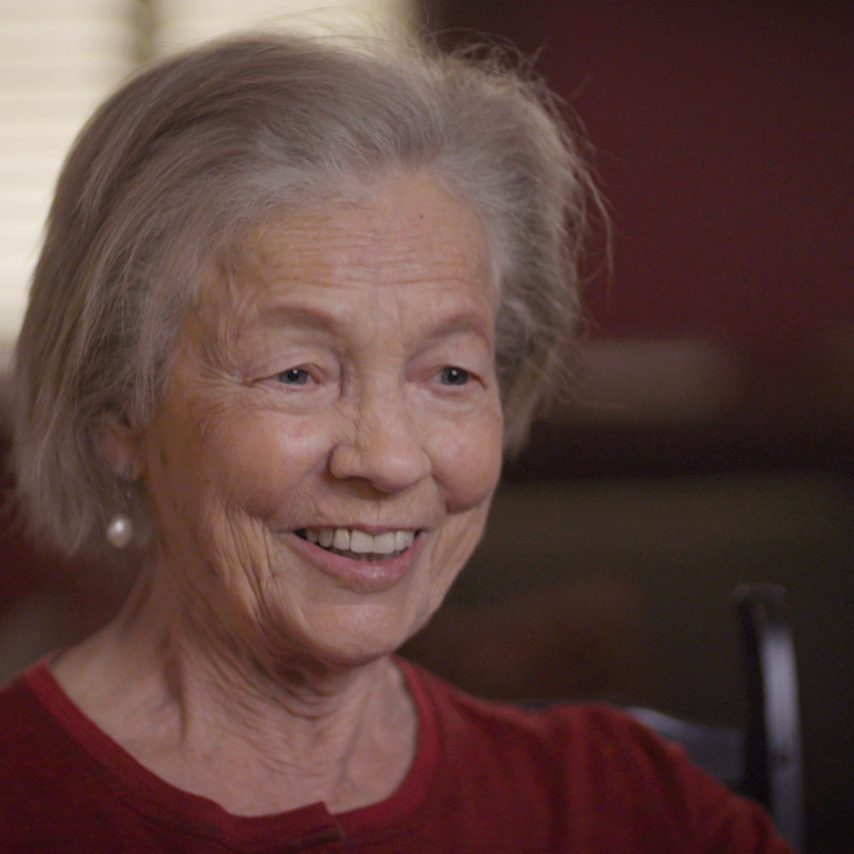 Color photo of Elizabeth Bartholet, smiling and seated indoors during her oral history interview.