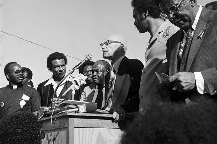 Black-and-white photo of Wiley Bolden speaking to a crowd at the Mobile County courthouse in Mobile, Alabama, during a rally held to support the reauthorization of the Voting Rights Act.