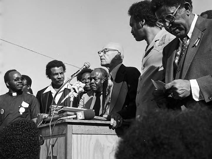 Black-and-white photo of Wiley Bolden speaking to a crowd at the Mobile County courthouse in Mobile, Alabama, during a rally held to support the reauthorization of the Voting Rights Act.