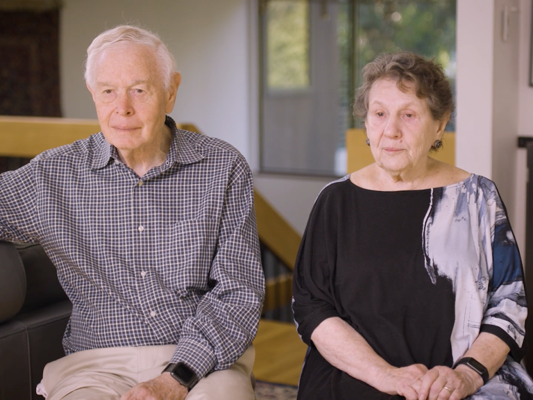 Color photo of Paul and Iris Brest seated indoors during their oral history interview.