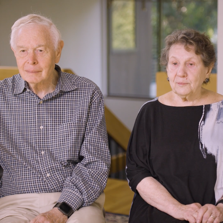 Color photo of Paul and Iris Brest seated indoors during their oral history interview.