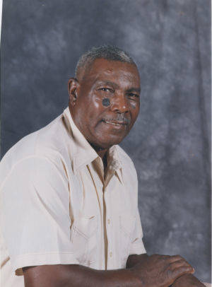 Portrait of Joseph Moody, wearing a white collared shirt against a gray background.