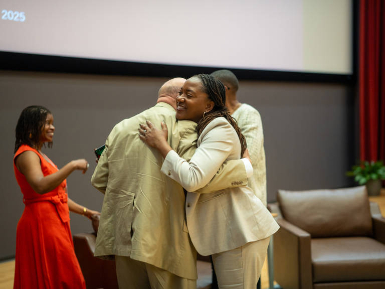 Janai Nelson hugs Theodore M. Shaw following the keynote conversation at the SOHP Spring Symposium on April 24, 2025.