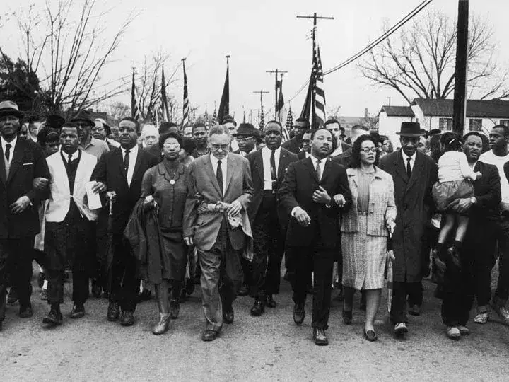 Black-and-white photo of a group of people participating in the 1965 Selma-to-Montgomery March.