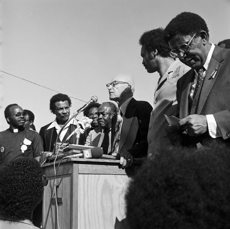 Black-and-white photo of Wiley Bolden speaking to a crowd at the Mobile County Courthouse in Mobile, Alabama, during a rally held to support the reauthorization of the Voting Rights Act.