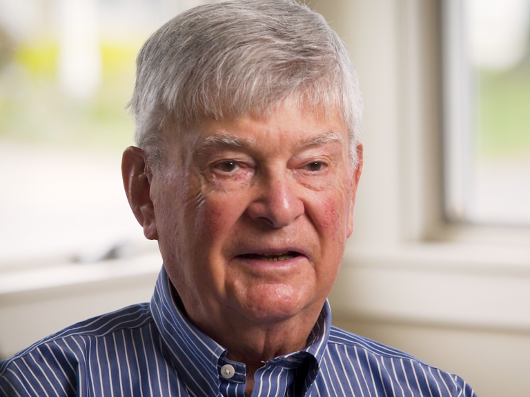 Color photo of Melvyn Zarr, seated indoors during his oral history interview.