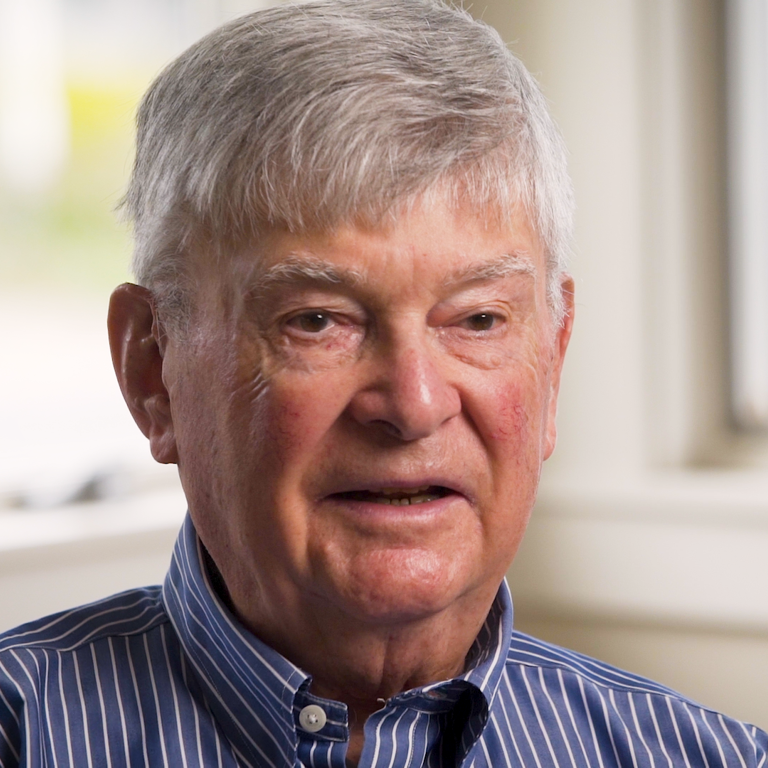 Color photo of Melvyn Zarr, seated indoors during his oral history interview.
