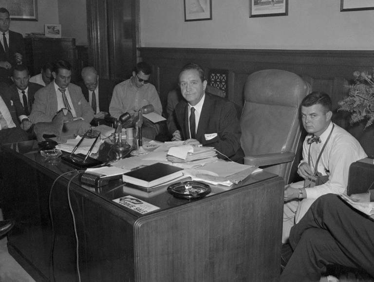 Photo of Governor Orval Faubus of Arkansas at his desk during a press conference, after President Dwight Eisenhower warned him to stop defying federal desegregation decrees with troops.