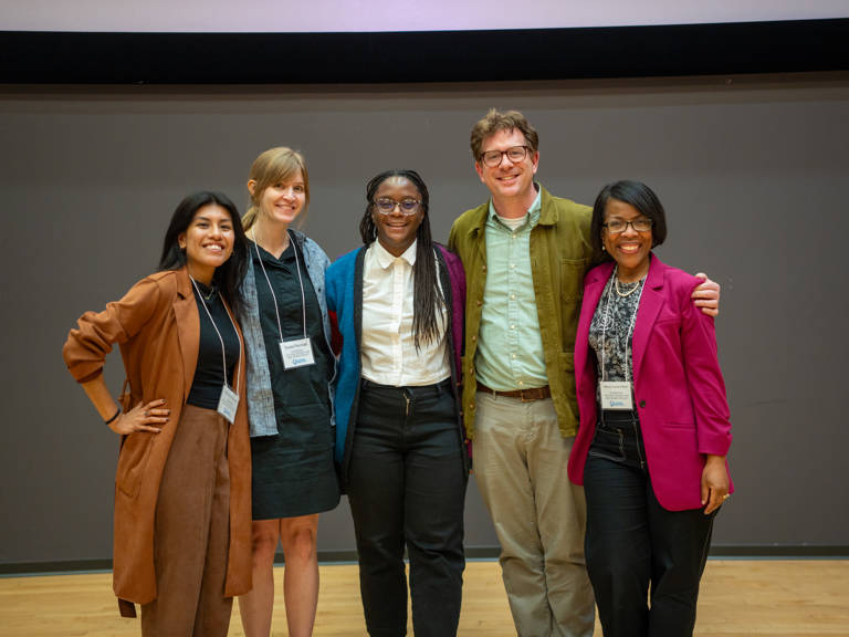 “Documenting the Good Fight: How LDF Stories Are Selected, Collected, and Preserved” panelists Kimberly Villafuerte Barzola, Susie Penman, Cassandra Mensah, Jesse Paddock and Melody Hunter-Pillion stand in front of a neutral gray wall at the SOHP Spring Symposium.
