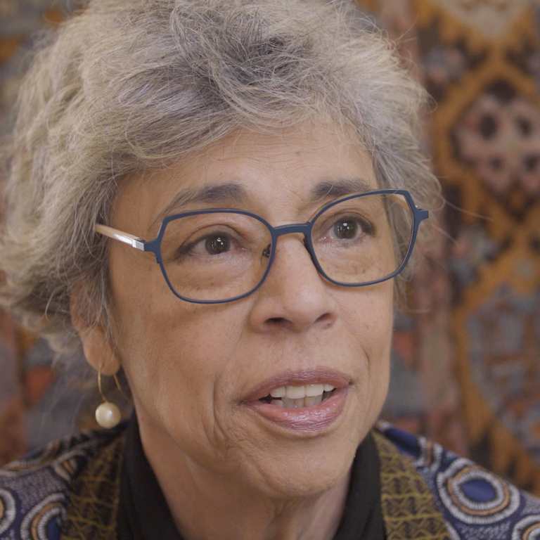 Color photo of Gabrielle Kirk McDonald, seated indoors and wearing glasses, during her oral history interview.