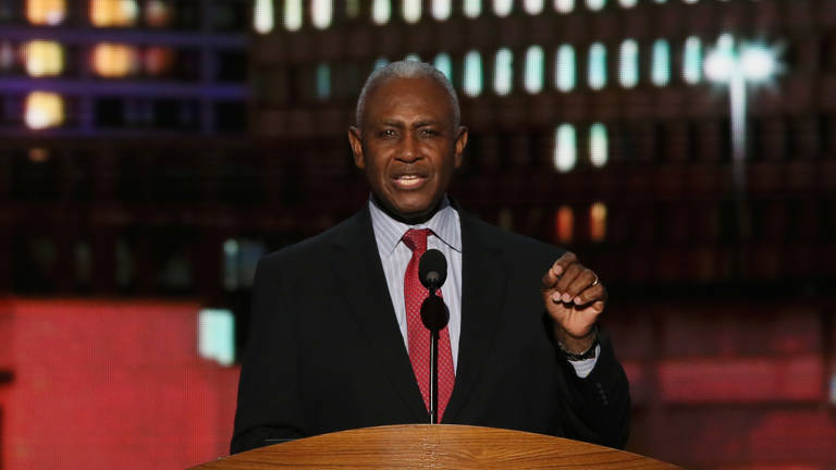 Color photo of Harvey Gantt wearing a suit and standing behind a podium as he speaks at the Democratic National Convention on September 6, 2012, in Charlotte, North Carolina.