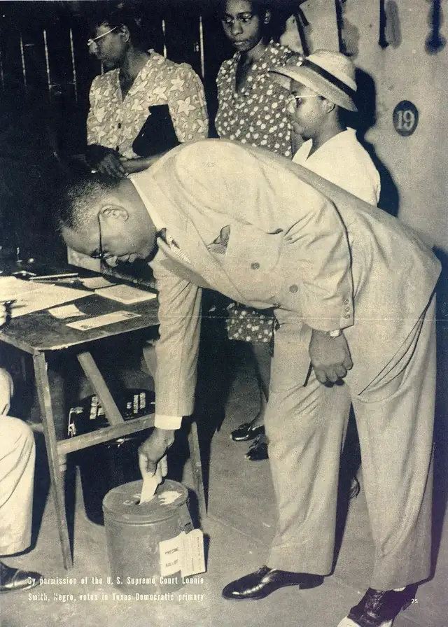 Black-and-white photo of Lonnie Smith, wearing a suit and bending down to place his ballot in the box for the Texas Democratic Primary.