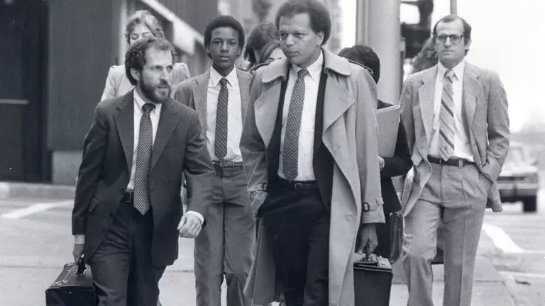 Black-and-white photo of Ted Shaw (third from left), LDF's fifth Director-Counsel, walking with colleagues on a sidewalk. They all wear suits and some carry briefcases.